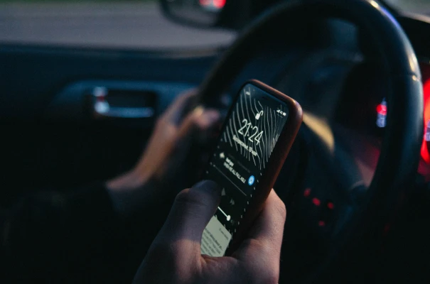 Holding a smartphone while sitting in a car